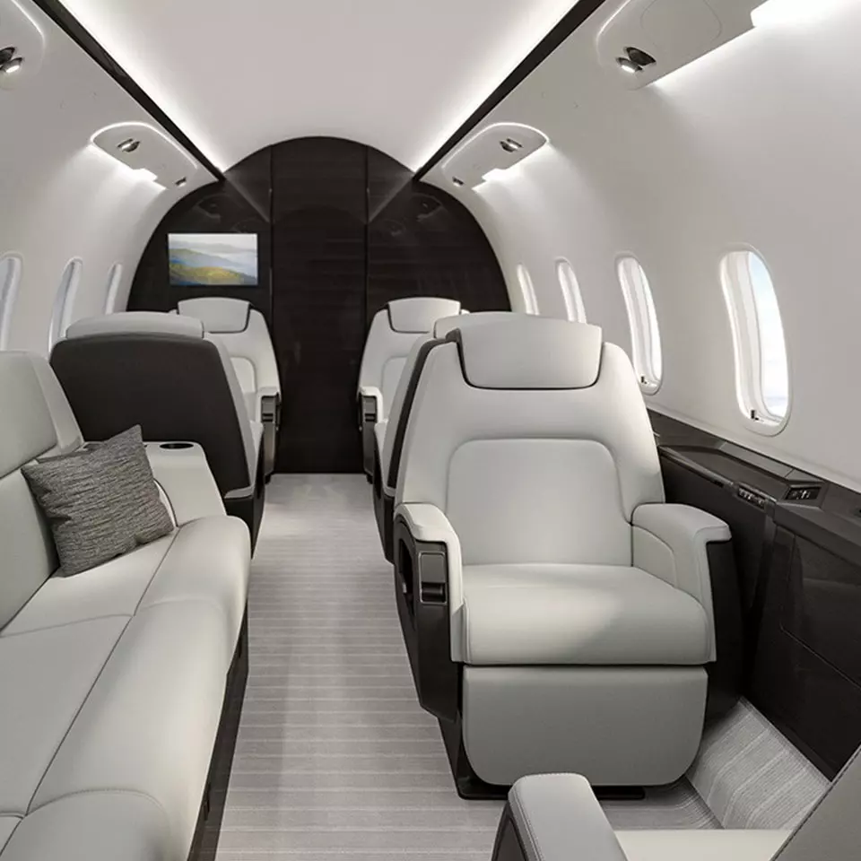 A white and black jet with couches in it